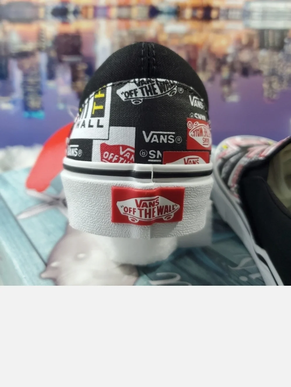 Vans Black Slip-On Sneakers with Red, White & Yellow Logo Print